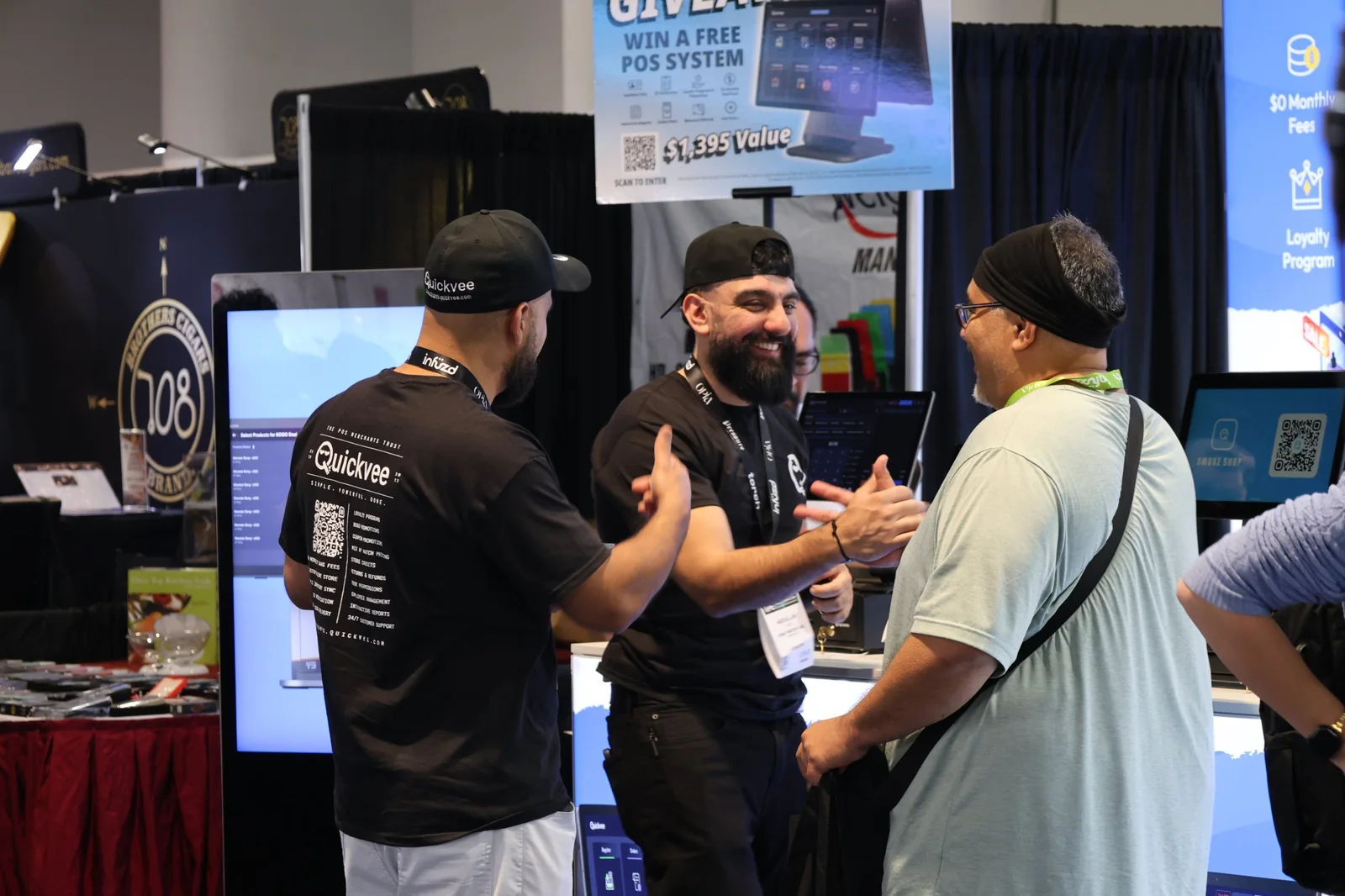Quickvee team greeting a shop owner at the Quickvee trade show booth